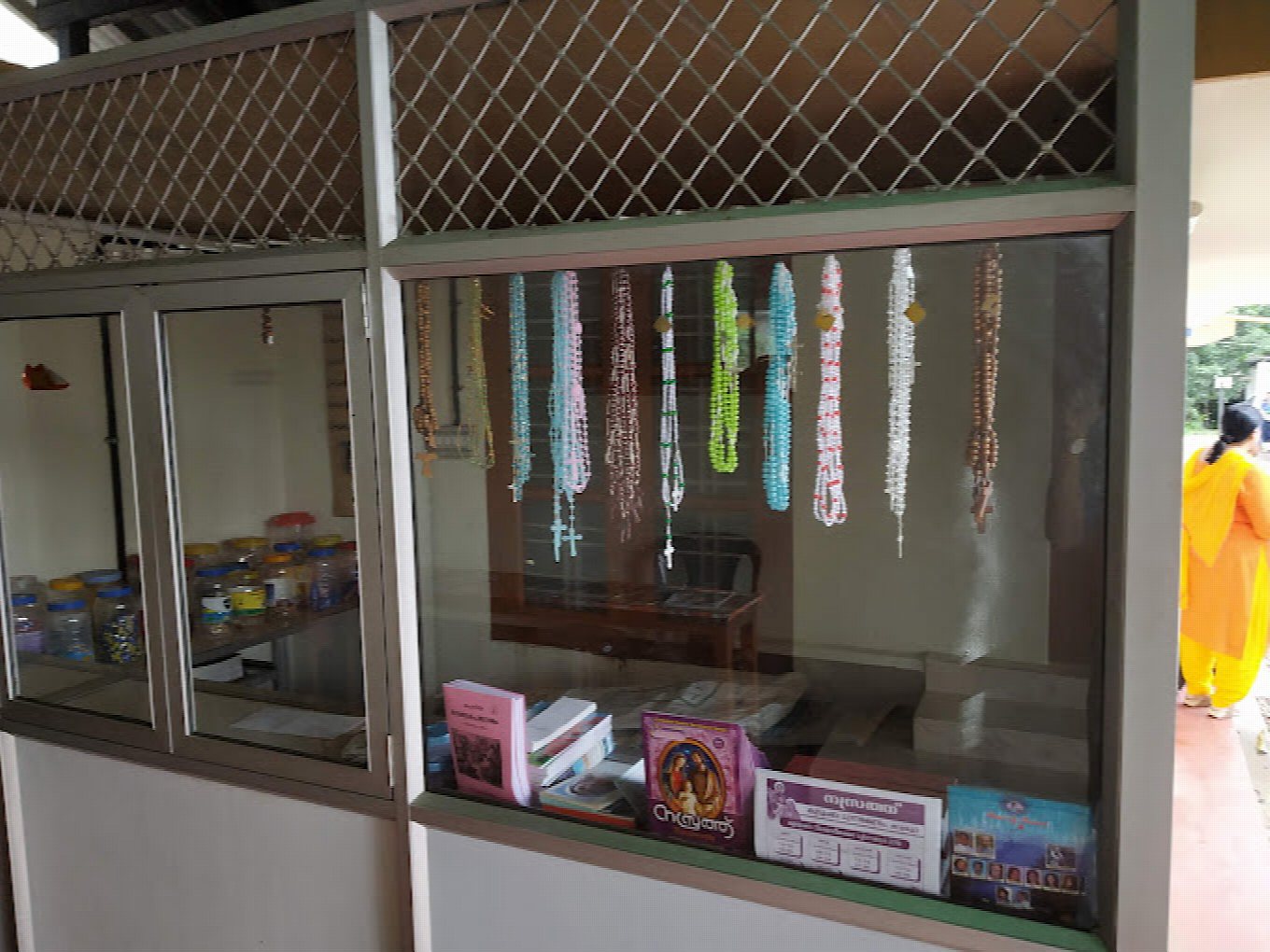 The counter by the entrance — rosaries, books and devotional articles