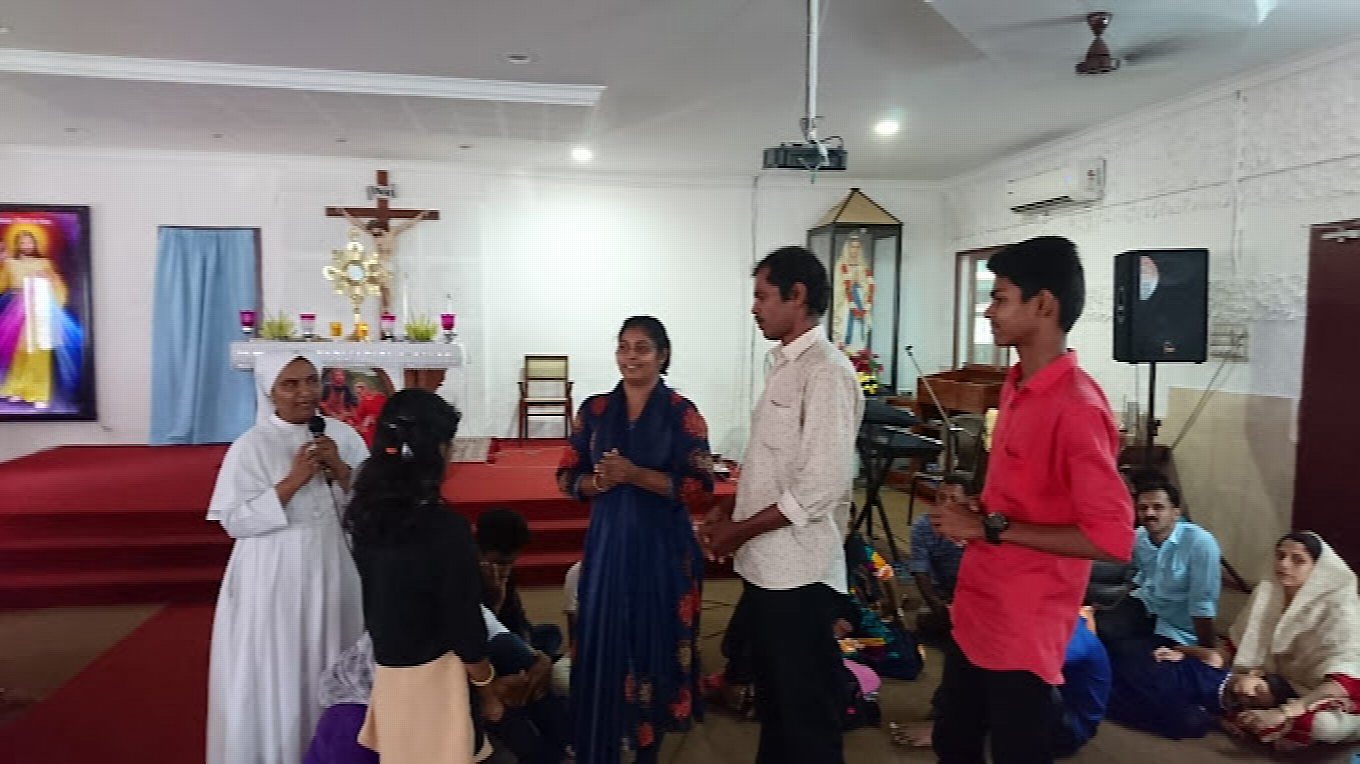 One of the sisters with families at the front of the hall
